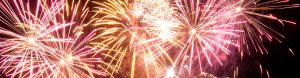 Close up of pink and gold fireworks in the night sky